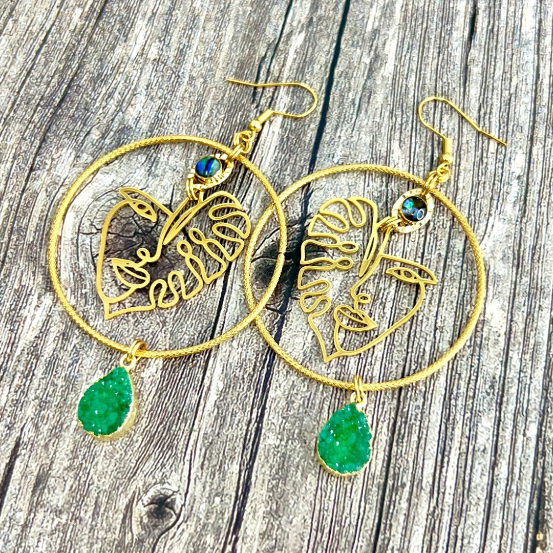 woman monstera gold earrings