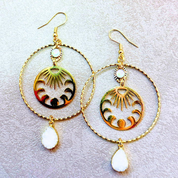 Statement hoop earrings with moon phases, sun rays, mother of pearl accents, and stunning druzy stones. 18K gold plated over tarnish-resistant stainless steel.